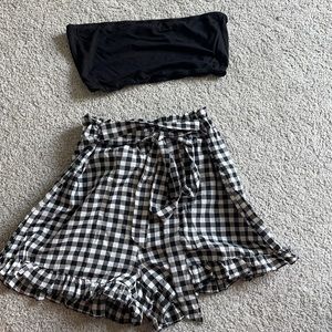 black tube top and checkered shorts